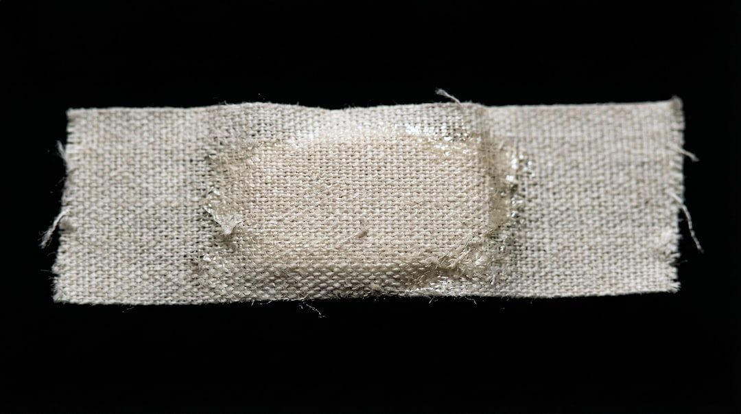 A patched wool blanket showing colourful visible mending